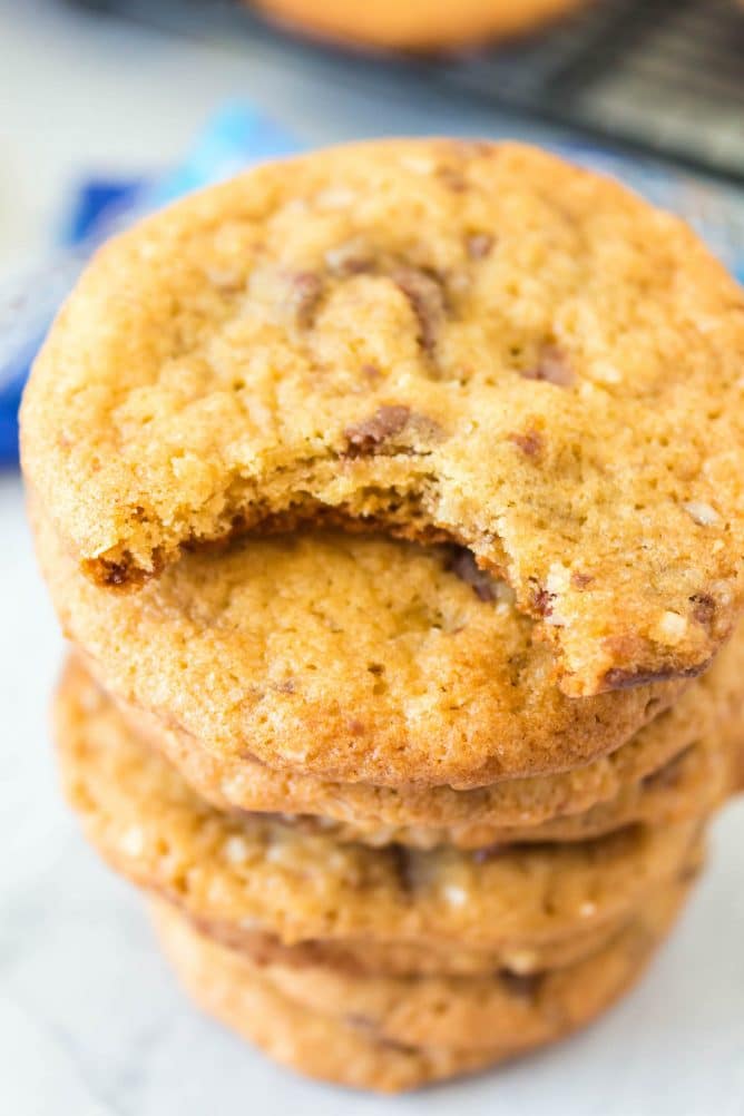 Close up shot of stack of almond joy cookies with top cookie missing one bite