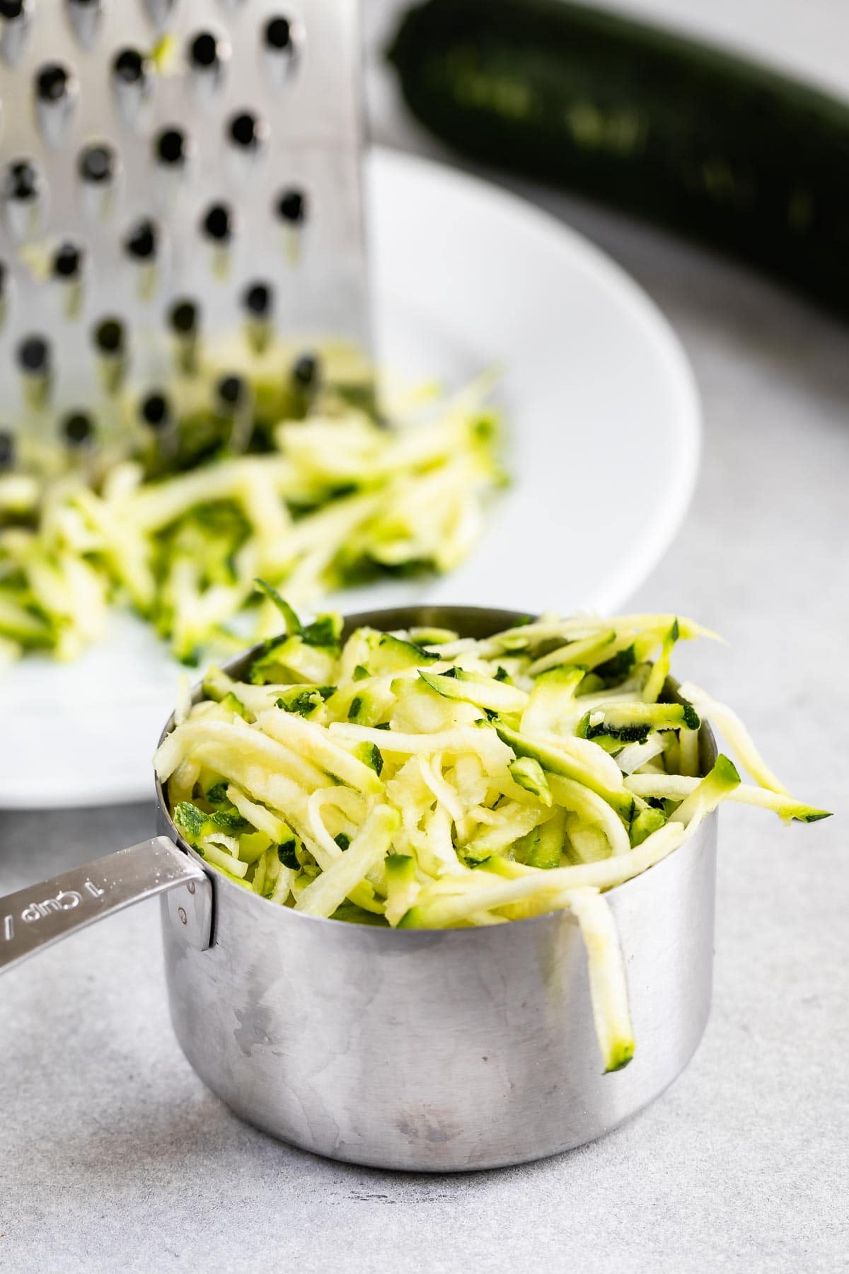 A cup full of shaved zucchini