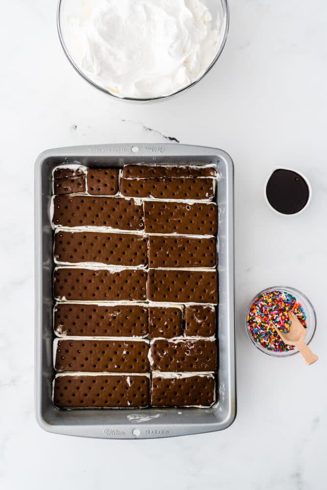 Easy Ice Cream Sandwich Cake | Crazy for Crust 3 Overhead process shot showing ice cream sandwiches laid out in a pan