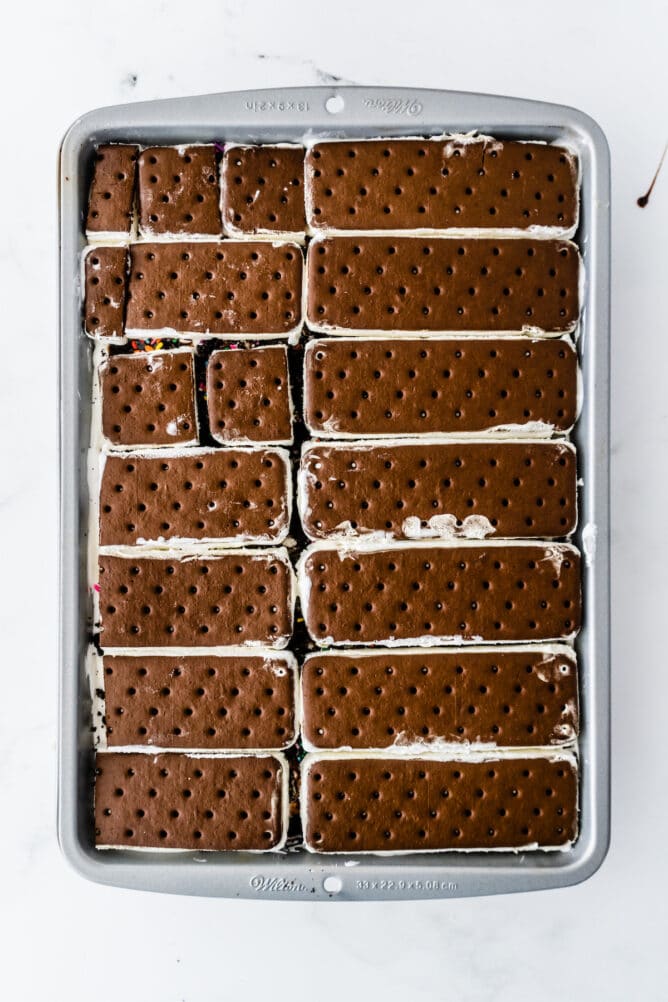 Overhead process shot showing ice cream sandwiches layered in cake pan