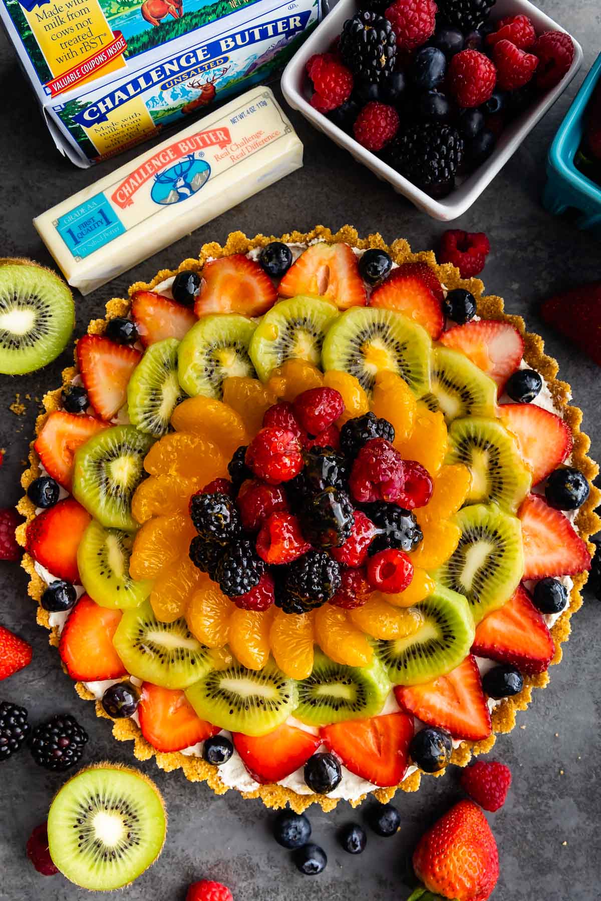 Overhead shot of no bake fruit tart with ingredients around it