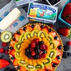 Overhead shot of no bake fruit tart with ingredients around it