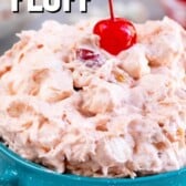Bowl of cherry fluff with a cherry on top and recipe title on image