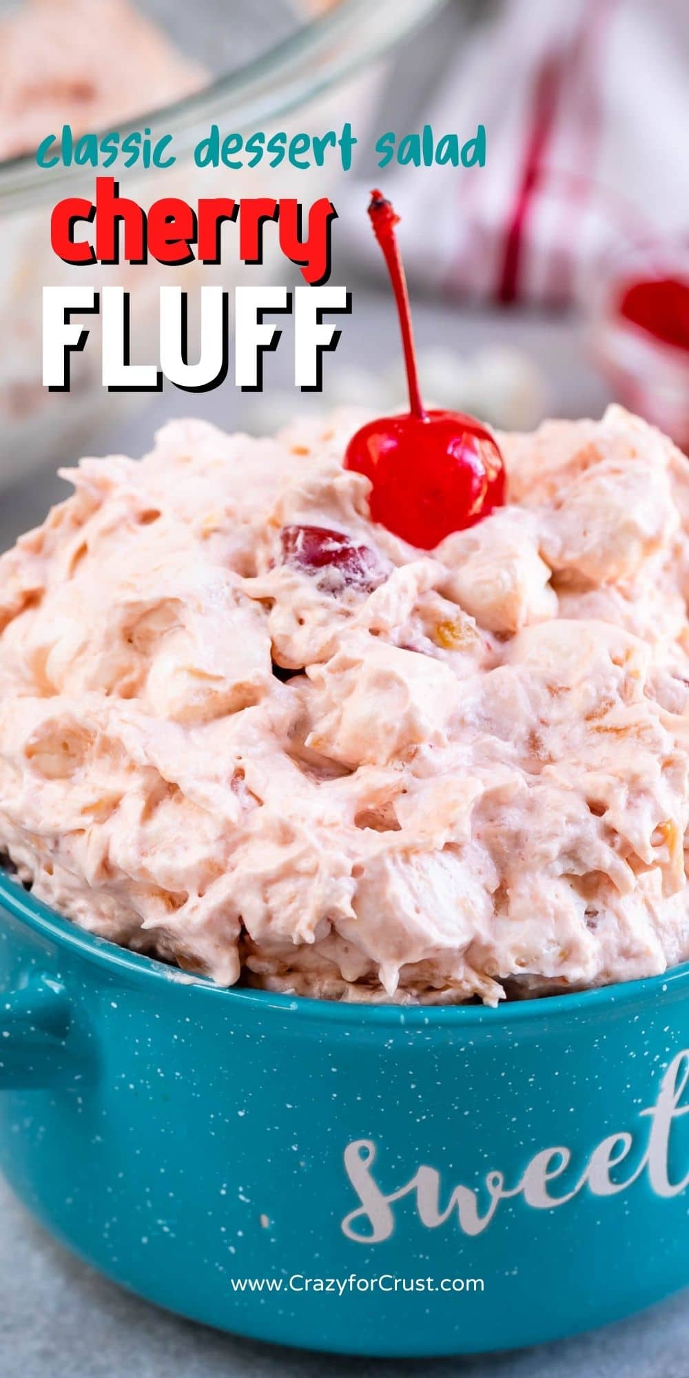 Bowl of cherry fluff with a cherry on top and recipe title on image