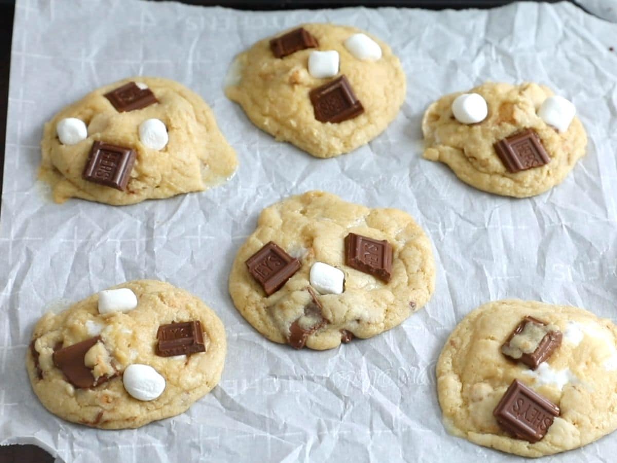 Six s'mores cookies on white parchment paper