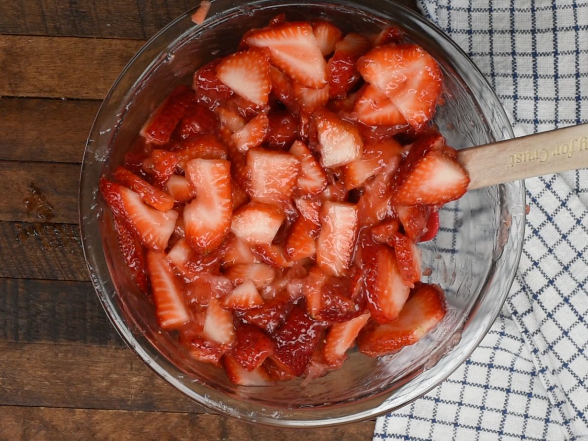 strawberries coated in strawberry mixture in bowl.