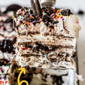 One corner piece of ice cream sandwich cake being scooped out of pan