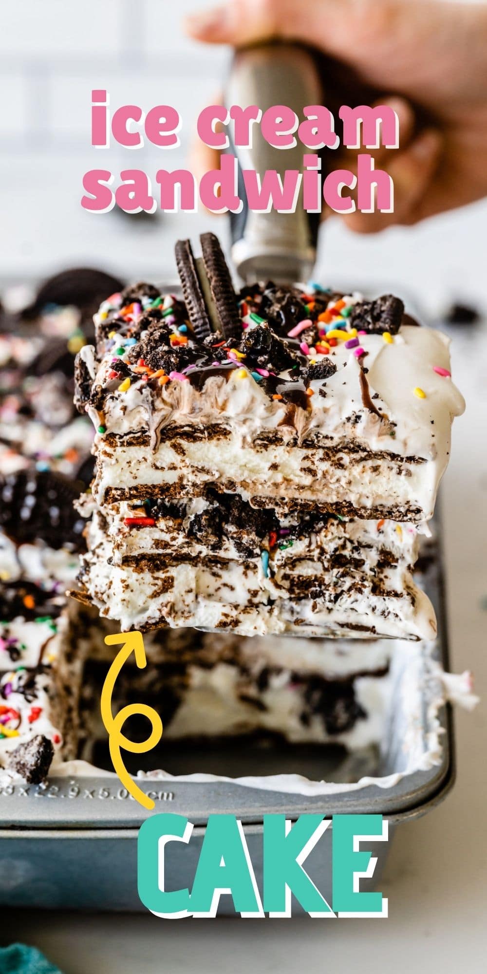 One corner piece of ice cream sandwich cake being scooped out of pan