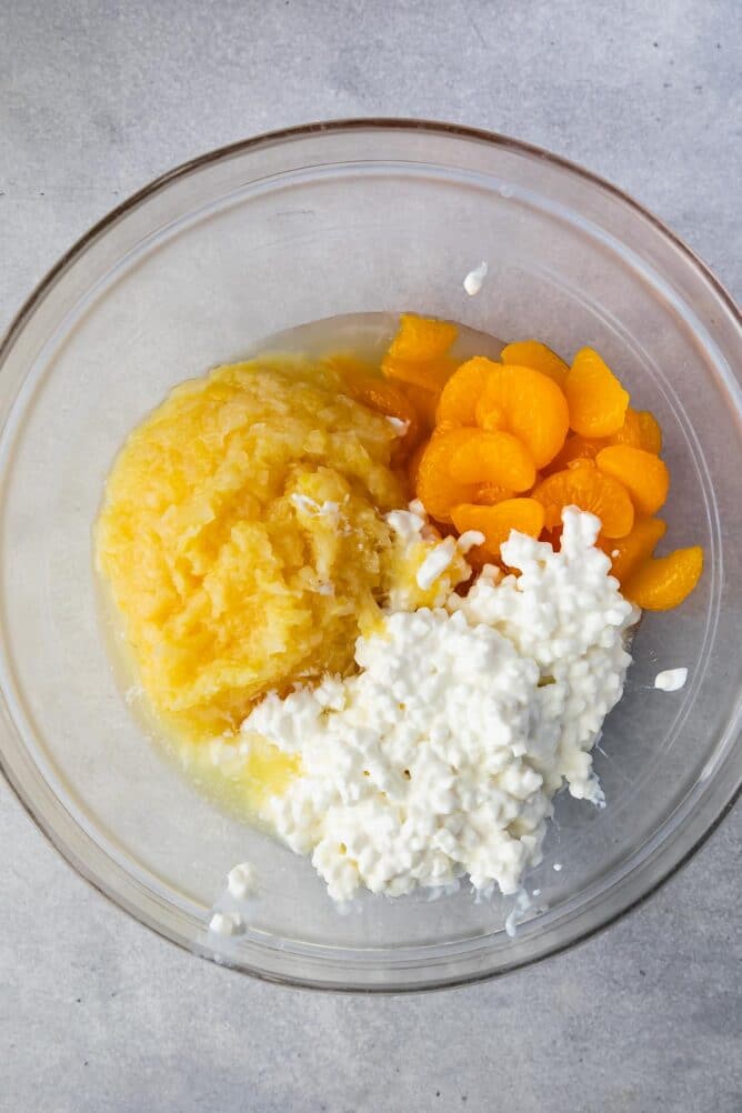 Overhead shot of bowl filled with cottage cheese, mandarin oranges and crushed pineapple
