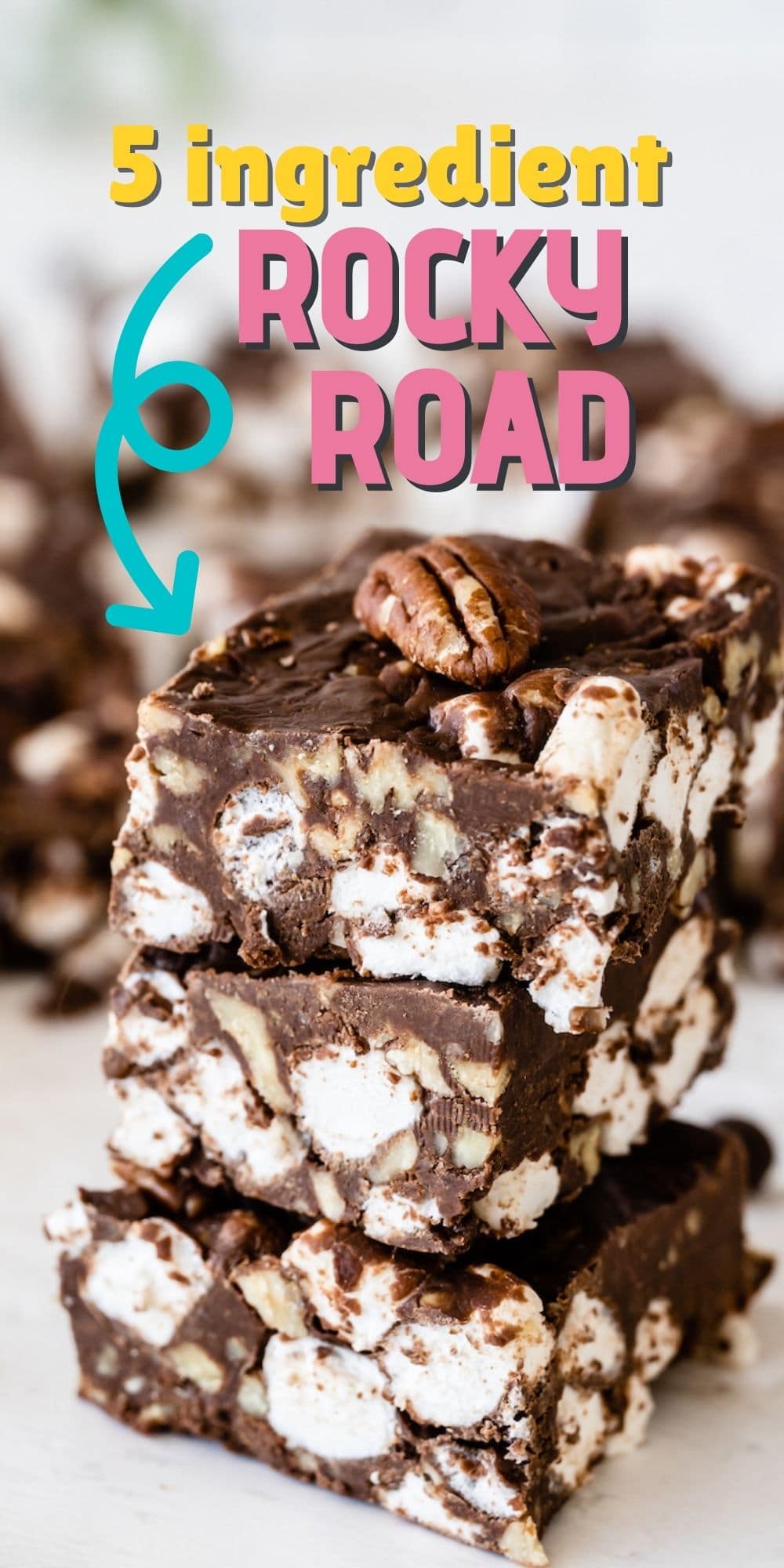 Three easy rocky road bars stacked on eachother with more in the background and recipe title on top of image