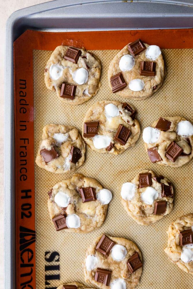 Overhead shot of s'mores cookies on a silicon baking mat fresh out of the oven