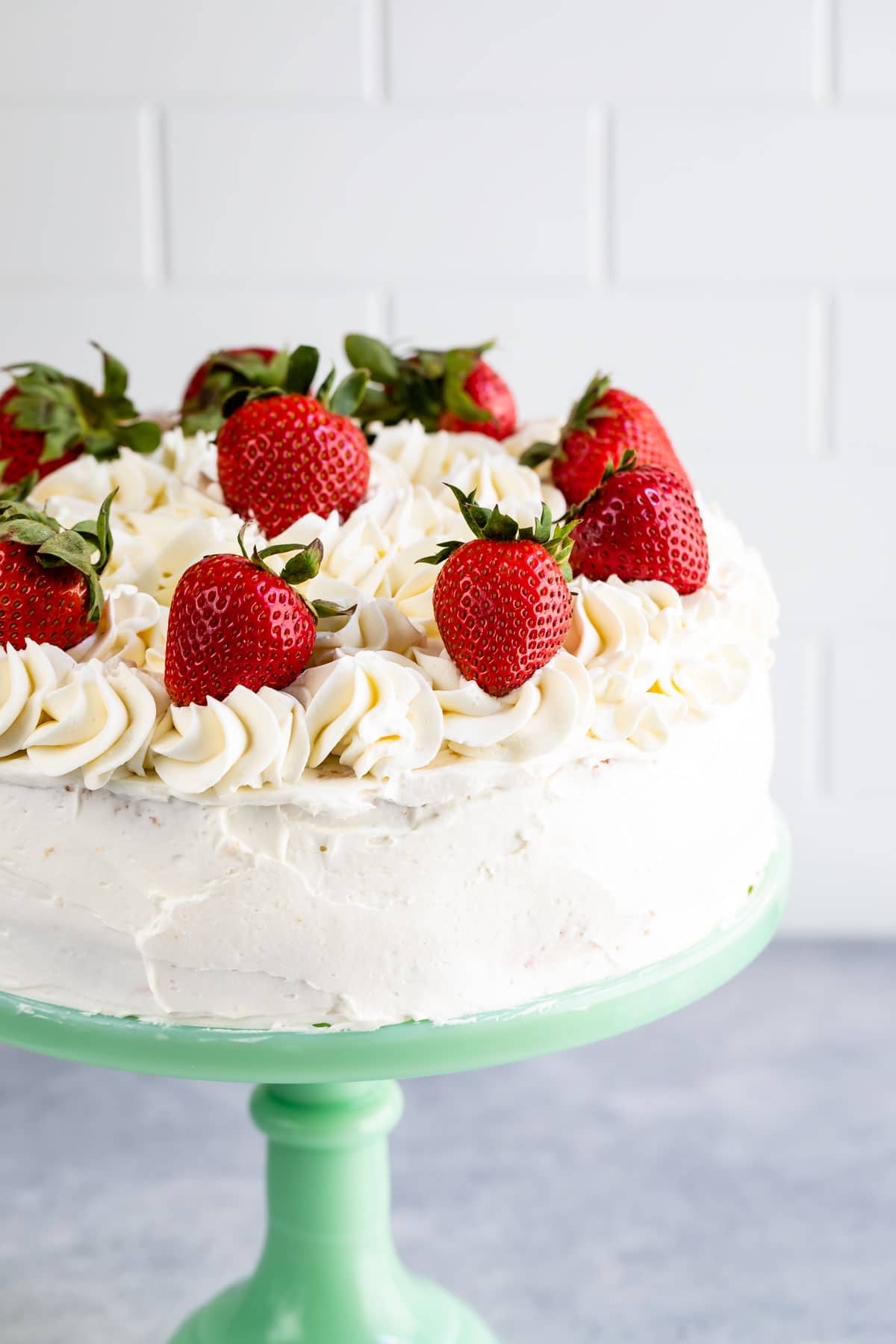 cake on mint cake plate with fresh strawberries on top