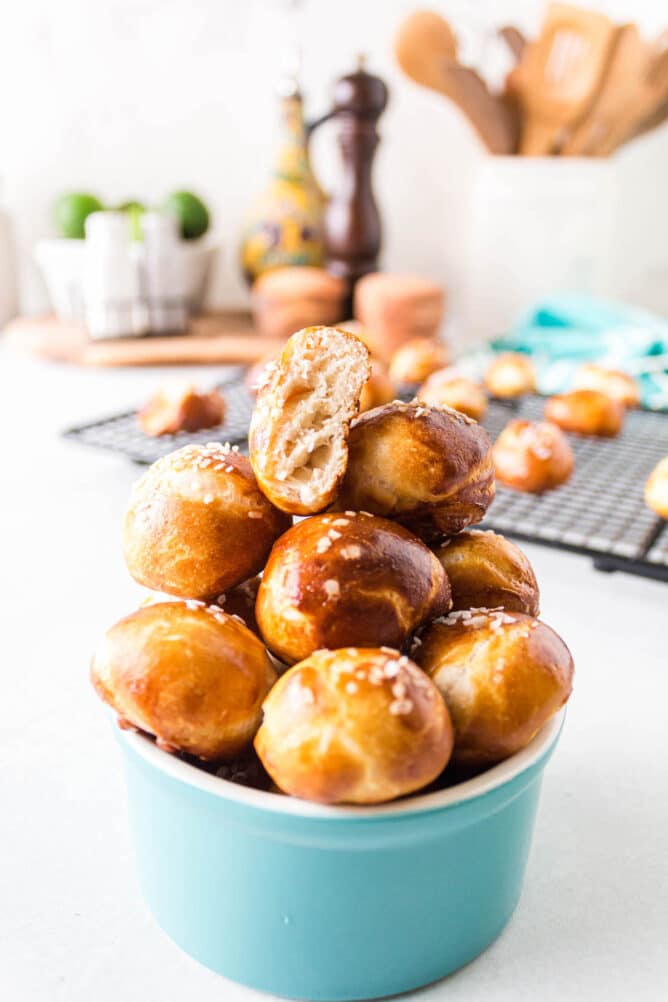 Small turquoise ramekin filled with pretzel bites