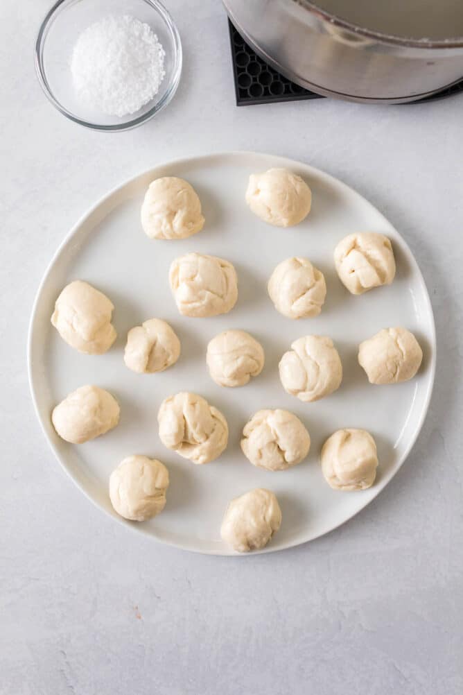 Overhead shot of pizza dough bites on a white plate