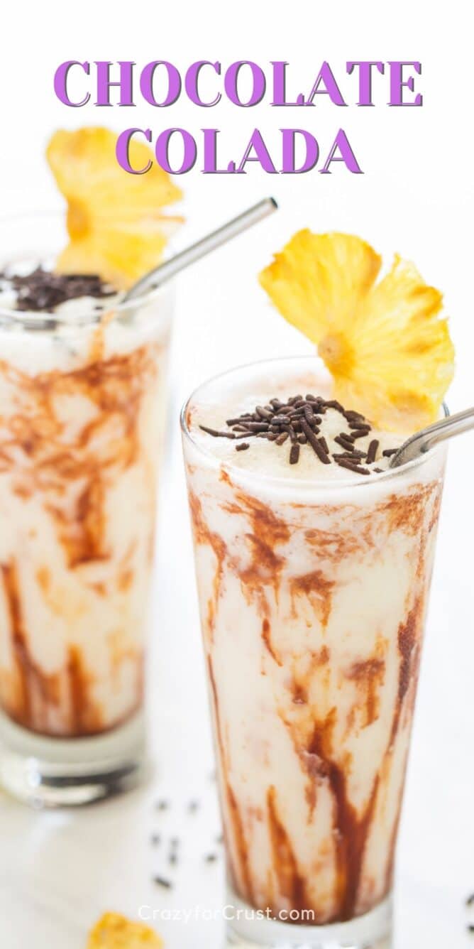 Two chocolate coladas with pineapple slices on top and recipe title on top of photo