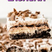 One piece of chocolate lasagna on spatula above the whole dessert with recipe title on top of image