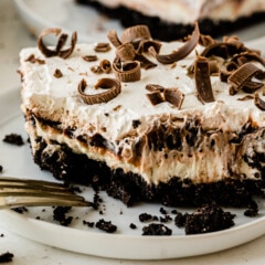 Slice of chocolate lasagna on plate with one bite missing