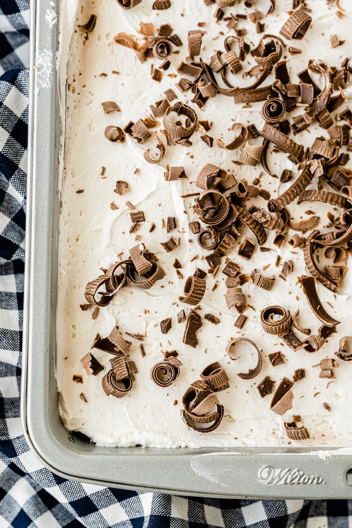 Overhead shot of chocolate lasagna in baking pan with shaved chocolate on top