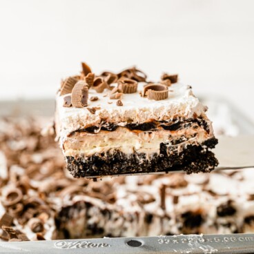 One piece of chocolate lasagna on spatula above the whole dessert