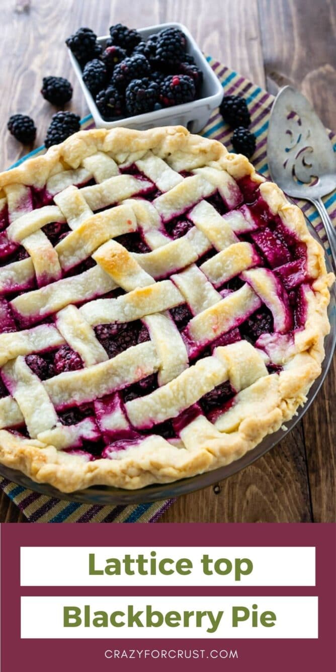 Lattice top blackberry pie with blackberries behind it and recipe title on bottom of photo