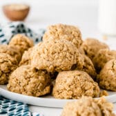 A bunch of peanut butter no bake cookies on a white plate