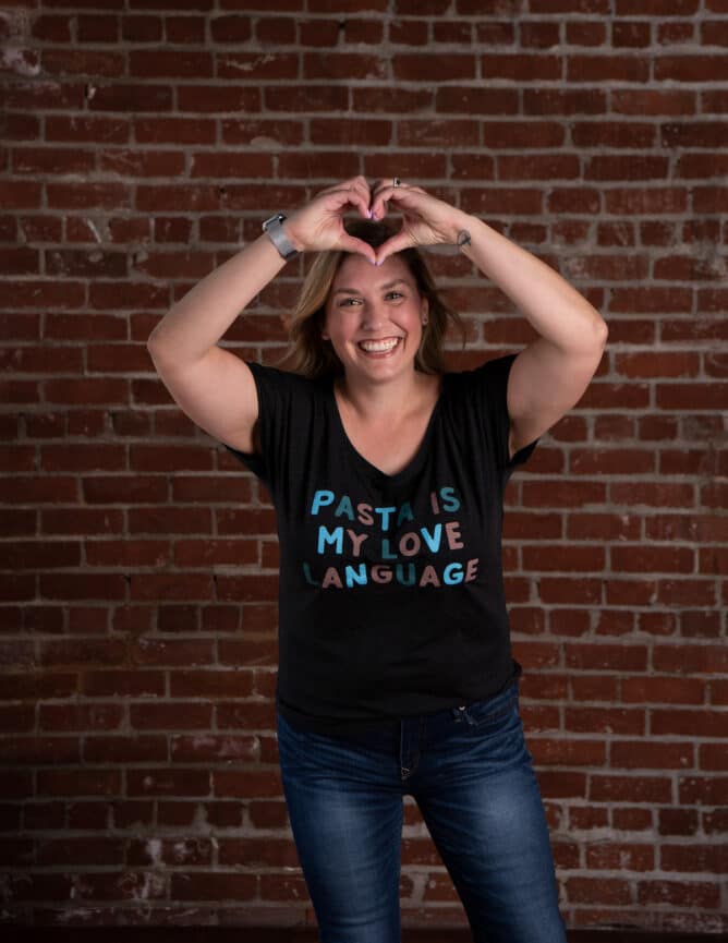 woman in black shirt making heart with hands