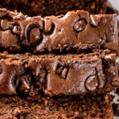 Overhead shot of sliced triple chocolate banana bread loaf with recipe title on top of image