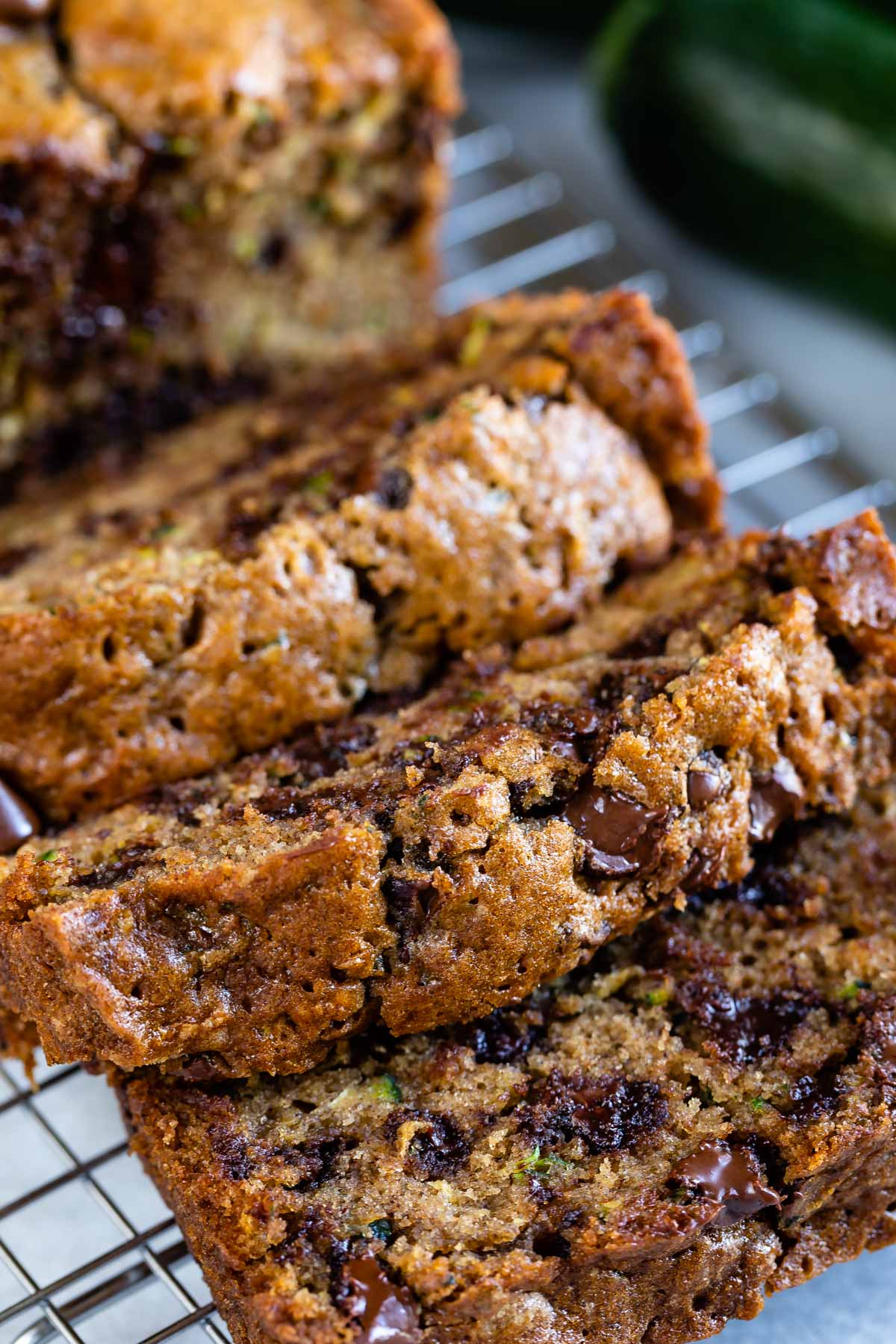 sliced zucchini bread with chocolate chips on rack