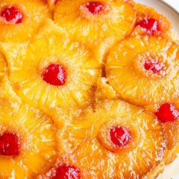 Overhead shot of pineapple upside down cake with recipe title on top of image