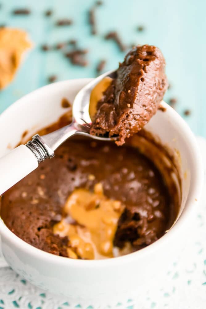 chocolate mug cookie with spoon on top with bite
