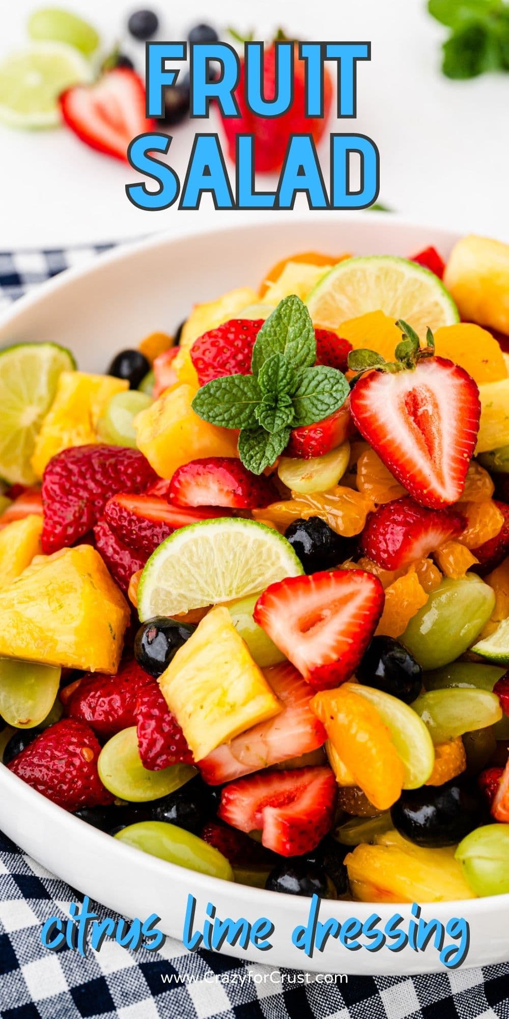 Bowl of fruit salad with recipe title on top of image