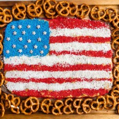 Overhead view of peanut butter flag dip with pretzels around it