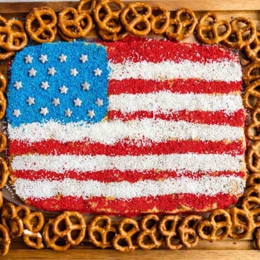 Overhead view of peanut butter flag dip with pretzels around it