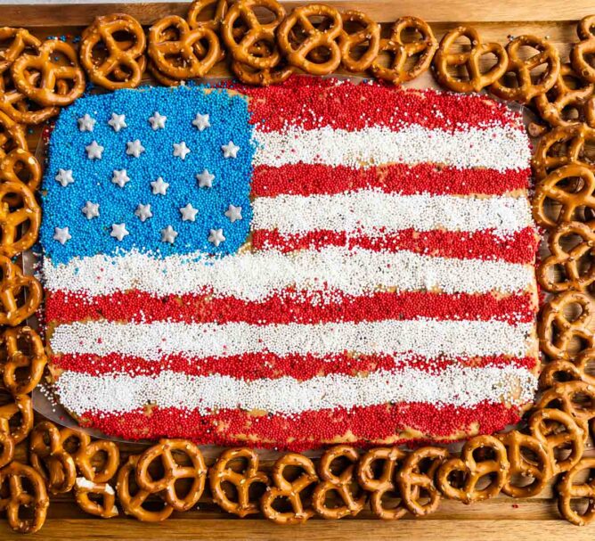 Overhead view of peanut butter flag dip with pretzels around it