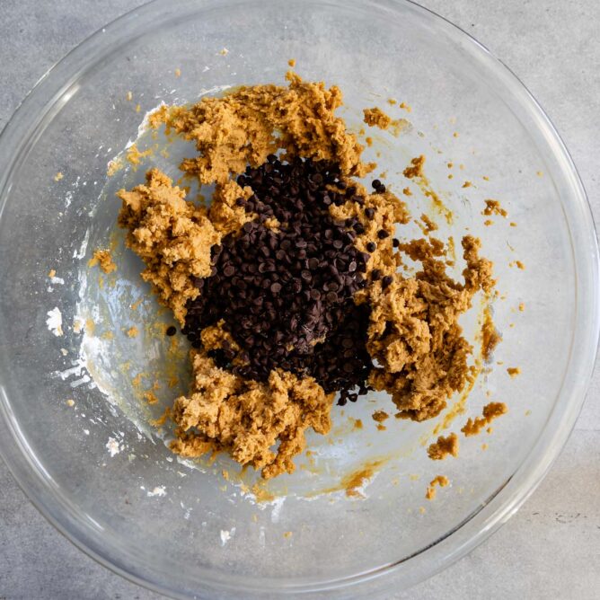 Overhead shot of peanut butter dip with chocolate chips in mixing bowl