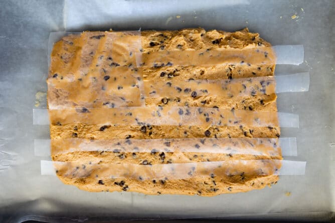 Overhead shot of peanut butter flag dip base with flag design being laid out on top