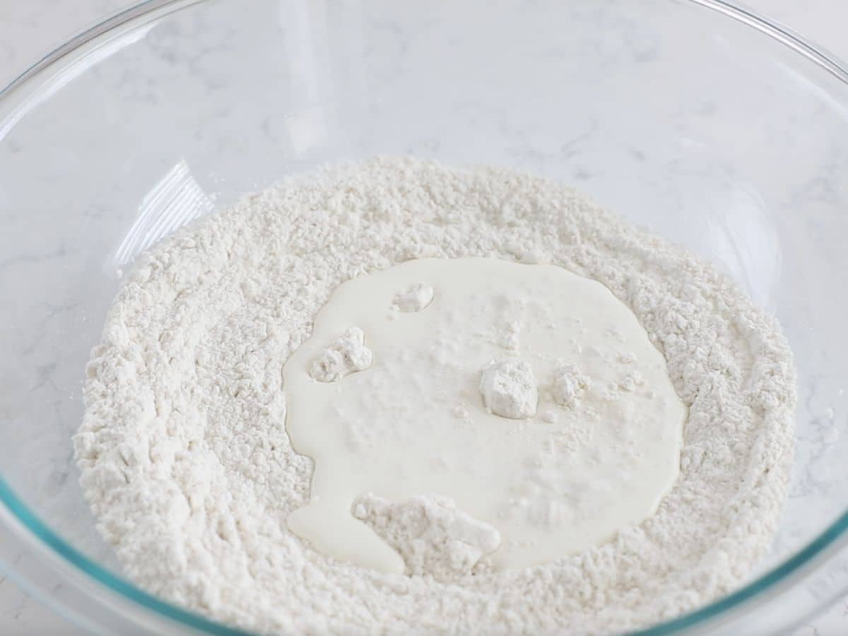 dry ingredients with cream in bowl.