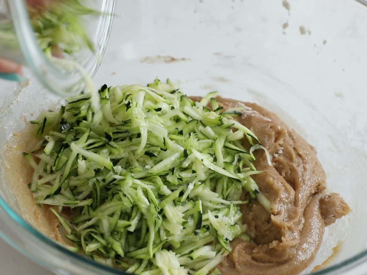 bowl of batter with shredded zucchini.