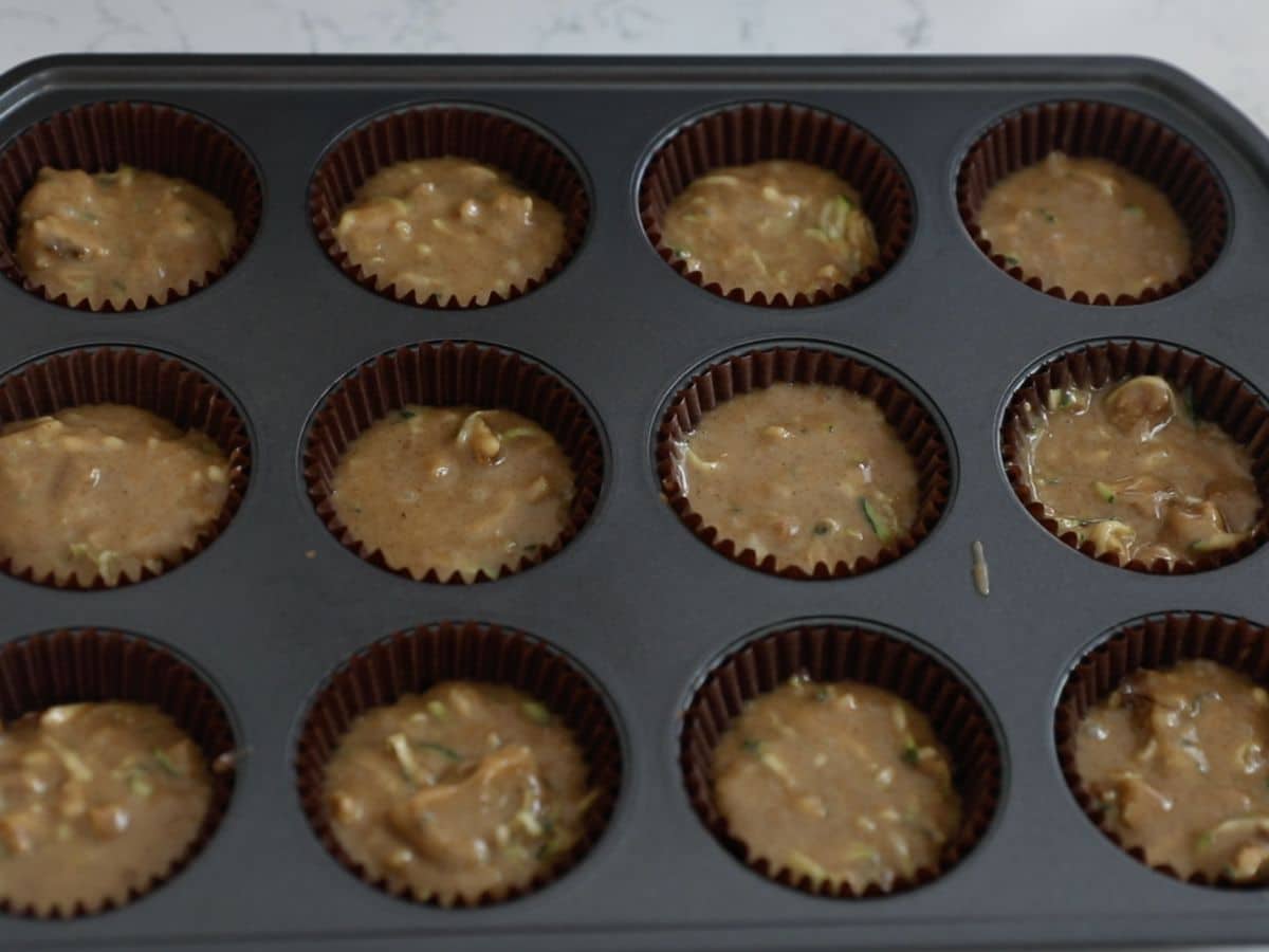 muffin pan with liners and batter.