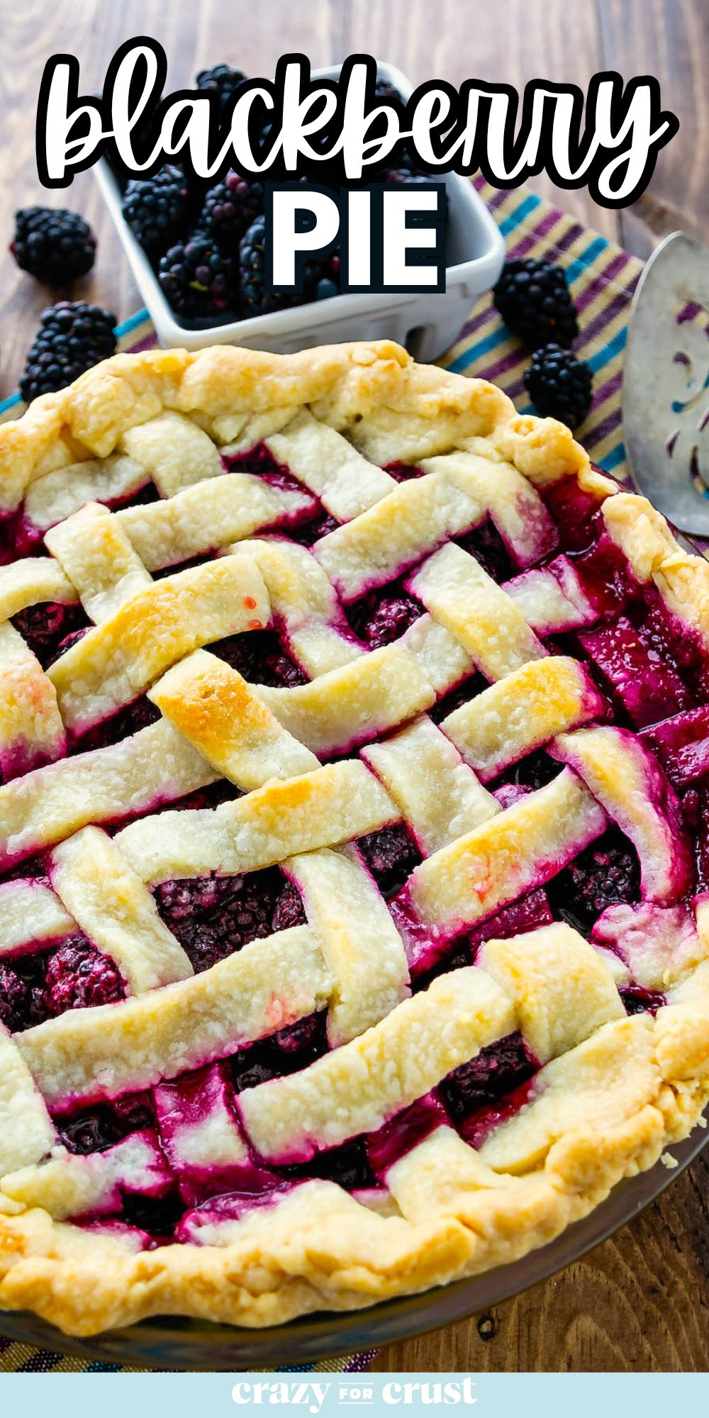 pie with lattice top with blackberries behind on wood surface