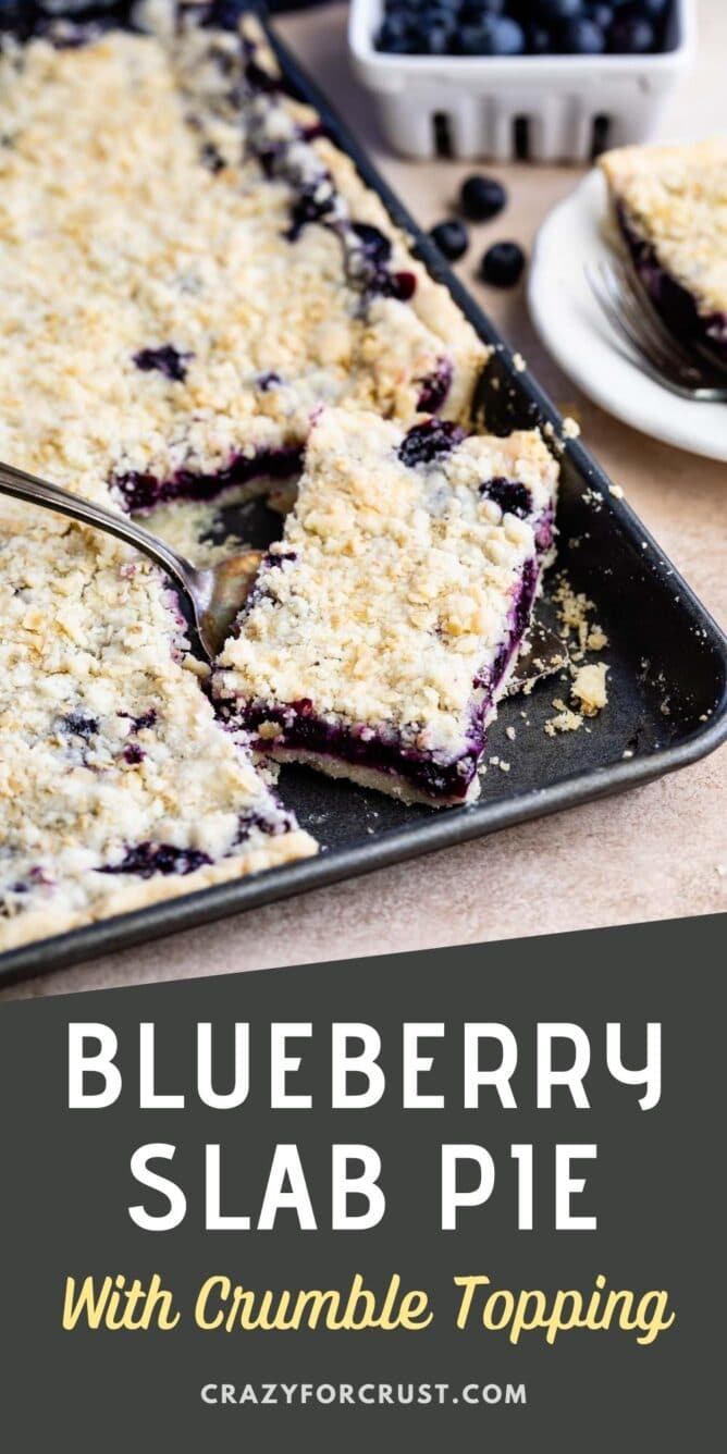 Blueberry slab pie in sheet pan with corner piece being scooped out with a serving spoon and recipe title on bottom of photo