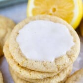 Stack of lemon cookies with icing on the top cookie