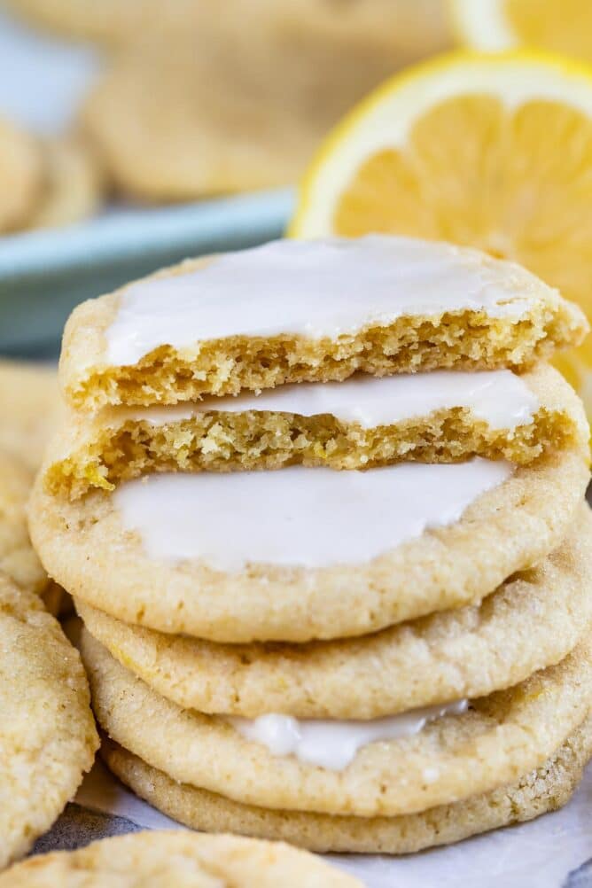 Stack of five iced lemon cookies with top on cut in half
