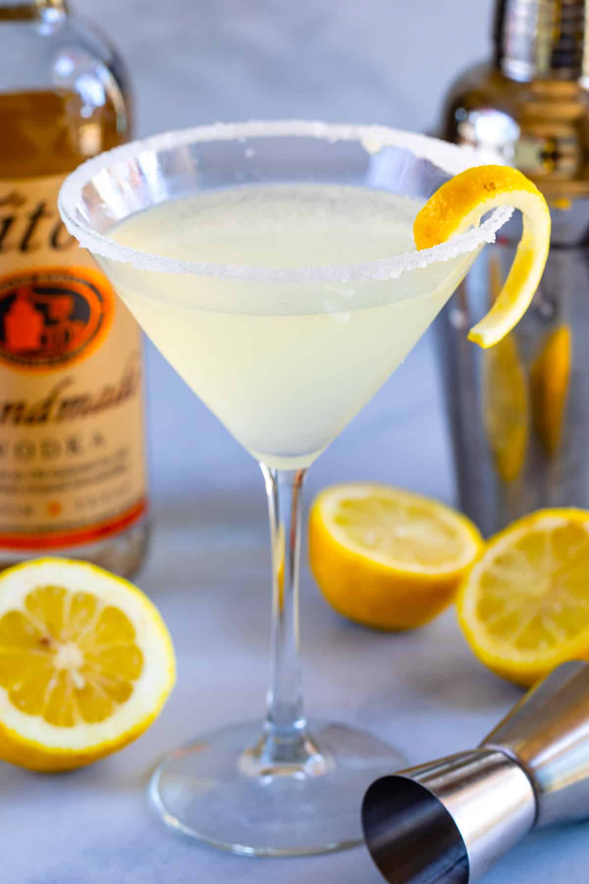 lemon drink in martini glass with shaker behind