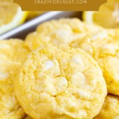 A bunch of lemon white chocolate cake mix cookies with recipe title on top of image