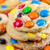 Stack of chocolate chip M&M cookies on parchment paper