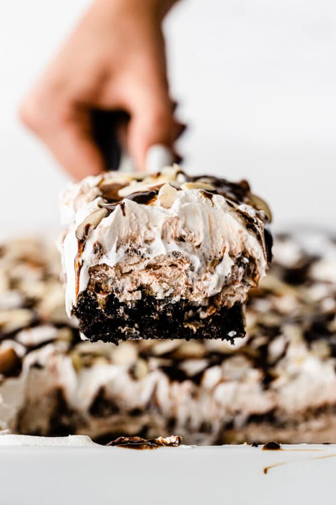 slice of mocha mud pie on spatula being held by hand