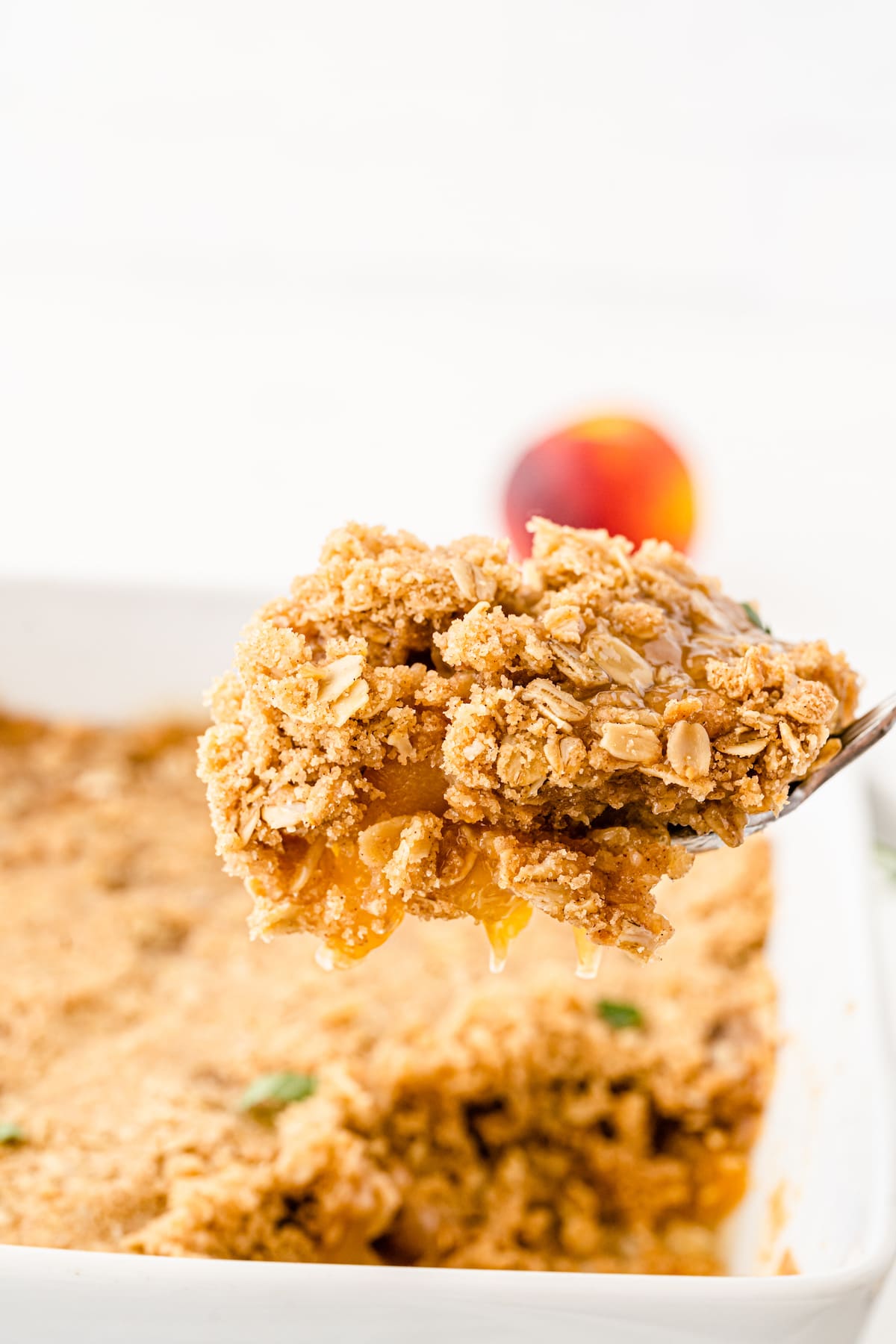 Close up shot of a spoonful of peach crisp