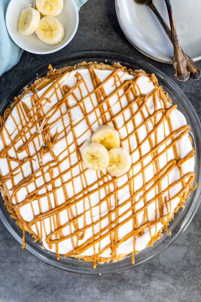 Overhead shot of no bake peanut butter banana cream pie with decorations on top