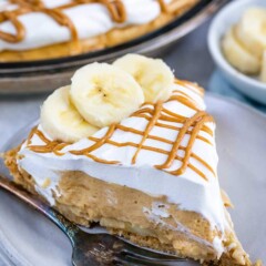 One slice of no bake peanut butter banana cream pie on plate